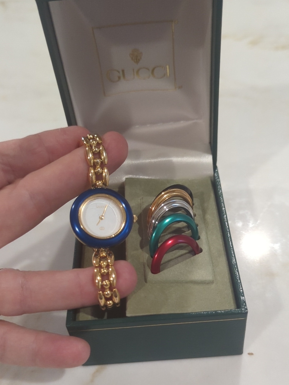 Gucci Gold Bracelet Watch with Blue Bezel and Multi-Color Interchangeable Bezels